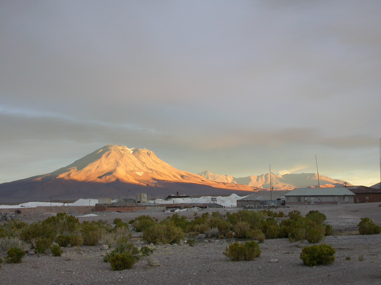 Ollagüe Volcano, viewed from the abandoned mining town of Amincha, ~30 km to the northwest. Ollagüe Volcano, viewed from the abandoned mining town of Amincha, ~30 km to the northwest.