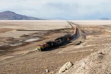 FCAB railway crossing the Carcote salt flat, northern Chile. The train covers the route Antofagasta – Calama – Ollagüe – Uyuni – La Paz, from 0 metres above level in the coastal city of Antofagasta to over 4,500 metres (14,800 ft) and has a total length of 1,537 km (955 mi). The locomotives have engines EMD GR12 2402, Clyde GL26C-2 2010 and Clyde GL26C-2 2005 whereas the Carcote salt flat has a surface of 108 square kilometers (42 sq mi)