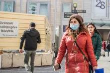 Women with red coat and a face mask