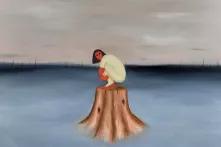 women sitting alone on a wooden log