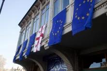 Georgian and EU flags hanging on the old building in Tbilisi