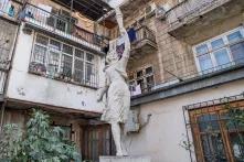 Statue in front of a residential building