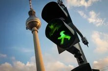 Green streetlight in front of Berlin Alexanderplatz tower