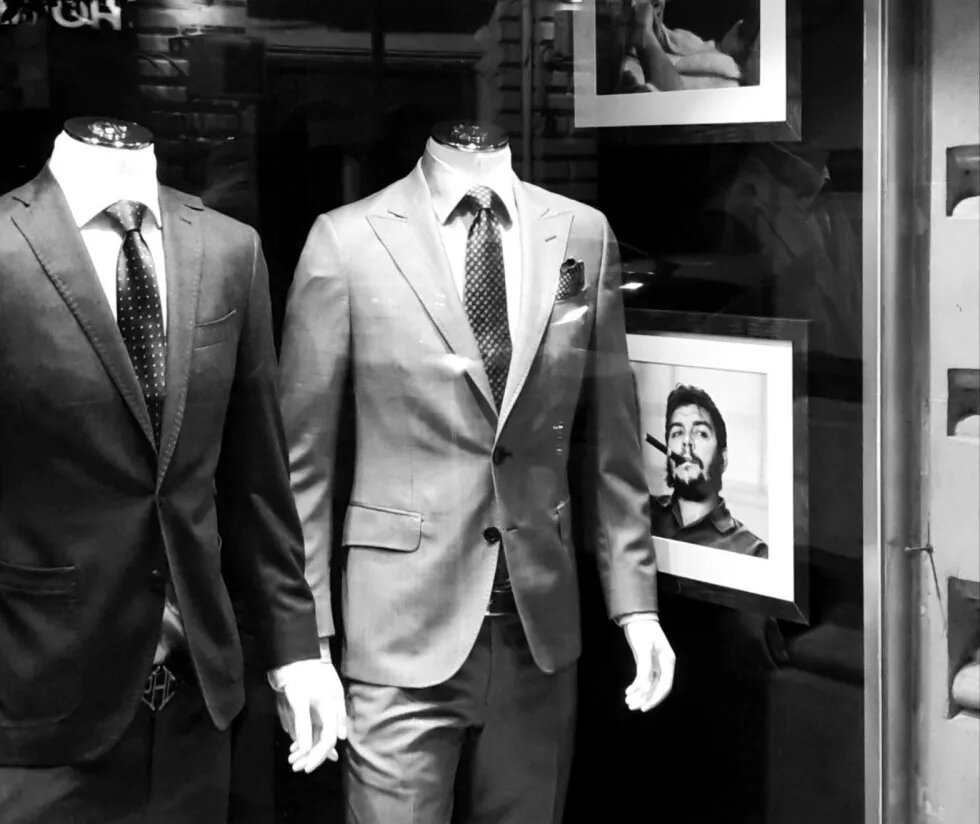 Men's suits in the shop's showcase, on the left side, Che Guevara's picture is hanging.