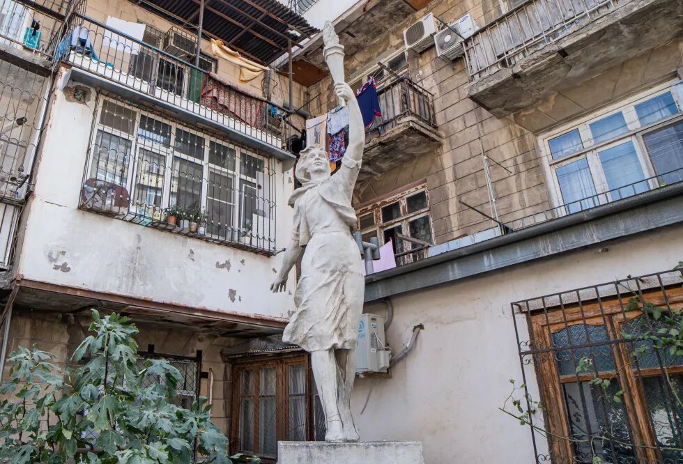 Statue in front of a residential building