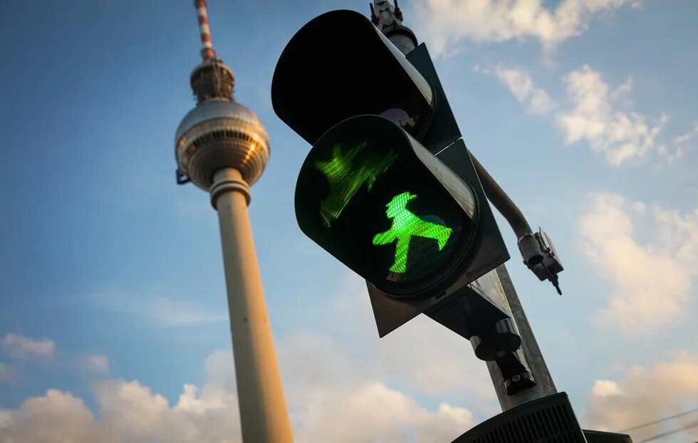 Green streetlight in front of Berlin Alexanderplatz tower